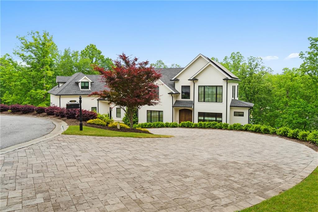 1285 Stuart Ridge Johns Creek, GA 30022 - Photo 85 of 89 a front view of a house with a yard and garage
