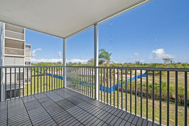 a view of balcony with wooden floor