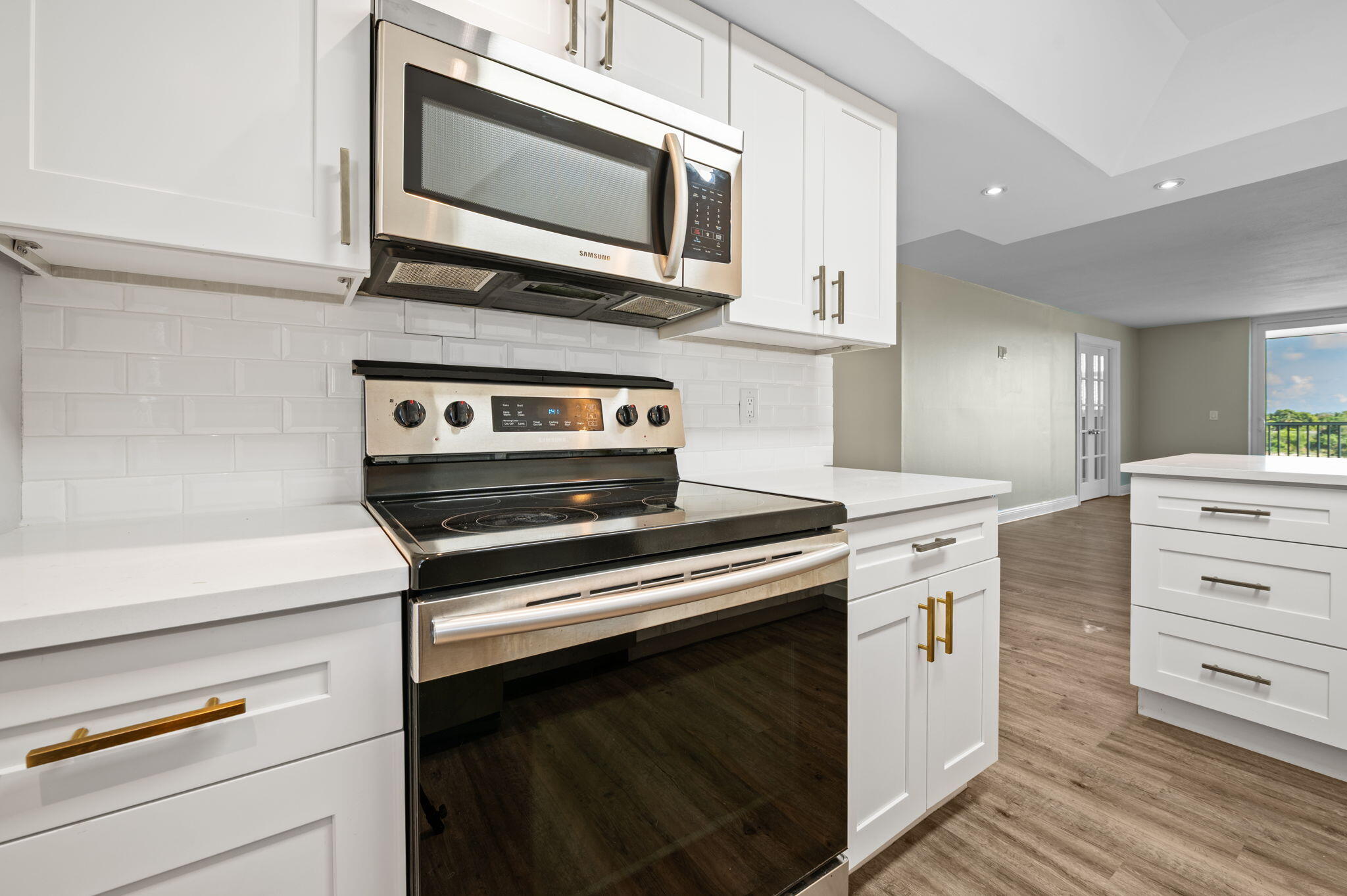 5700 Northwest 2nd Avenue, Unit 410 Boca Raton, FL 33487 - Photo 11 of 34 a kitchen with stainless steel appliances a stove microwave and cabinets