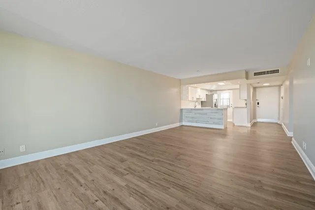 a view of an empty room and wooden floor
