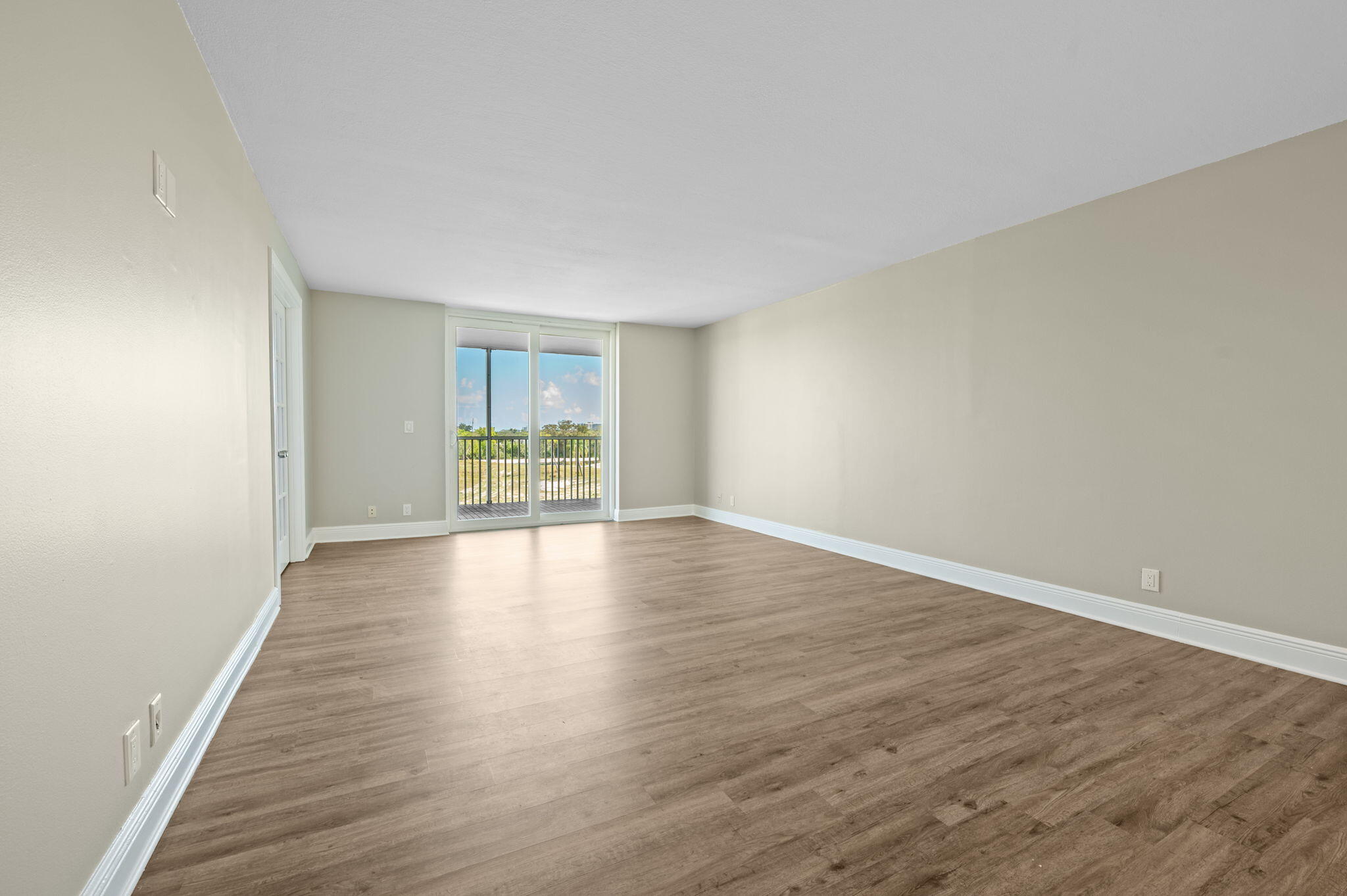 5700 Northwest 2nd Avenue, Unit 410 Boca Raton, FL 33487 - Photo 13 of 34 a view of an empty room with wooden floor and a window