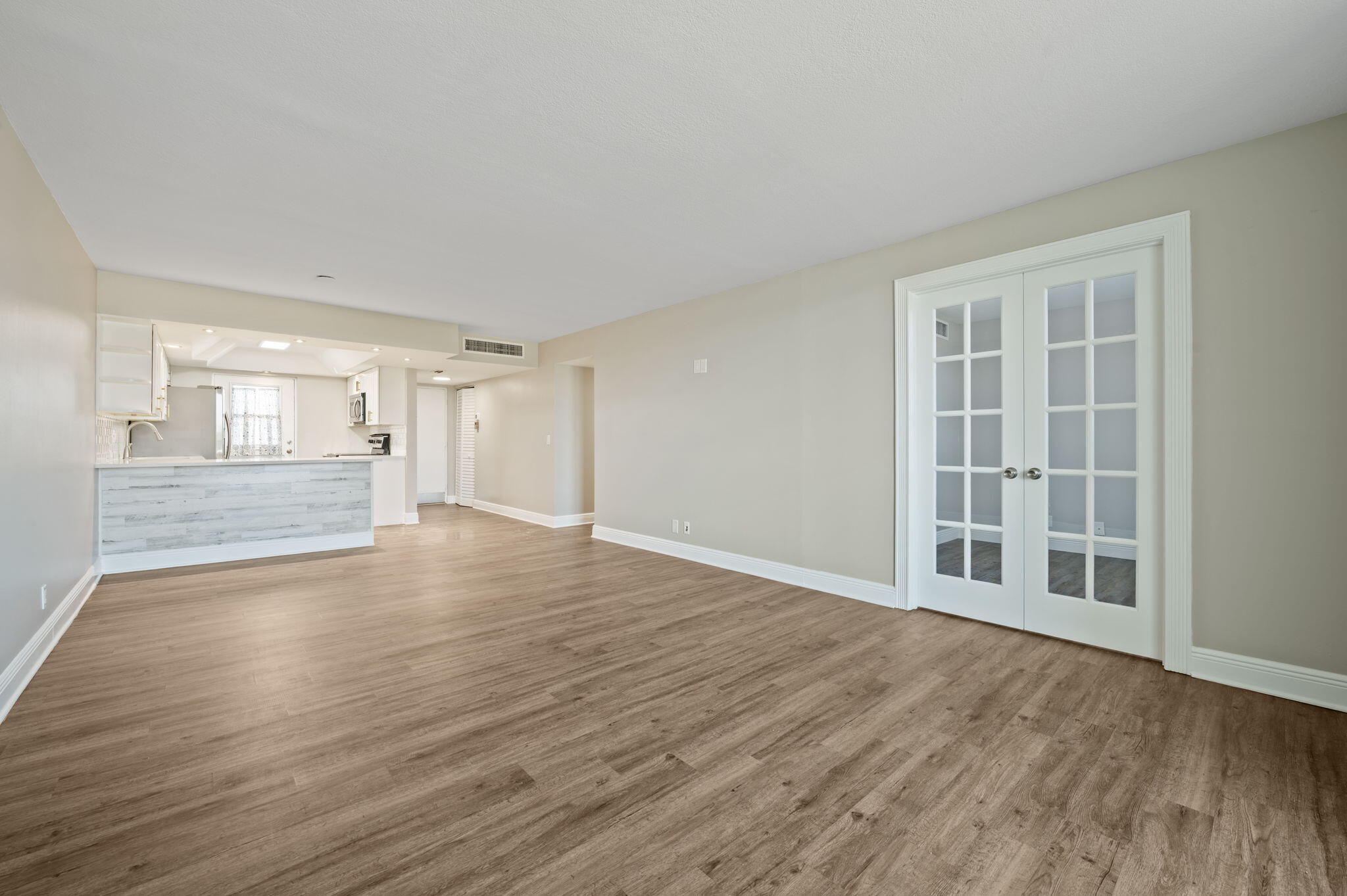5700 Northwest 2nd Avenue, Unit 410 Boca Raton, FL 33487 - Photo 15 of 34 a view of an empty room with wooden floor and a window