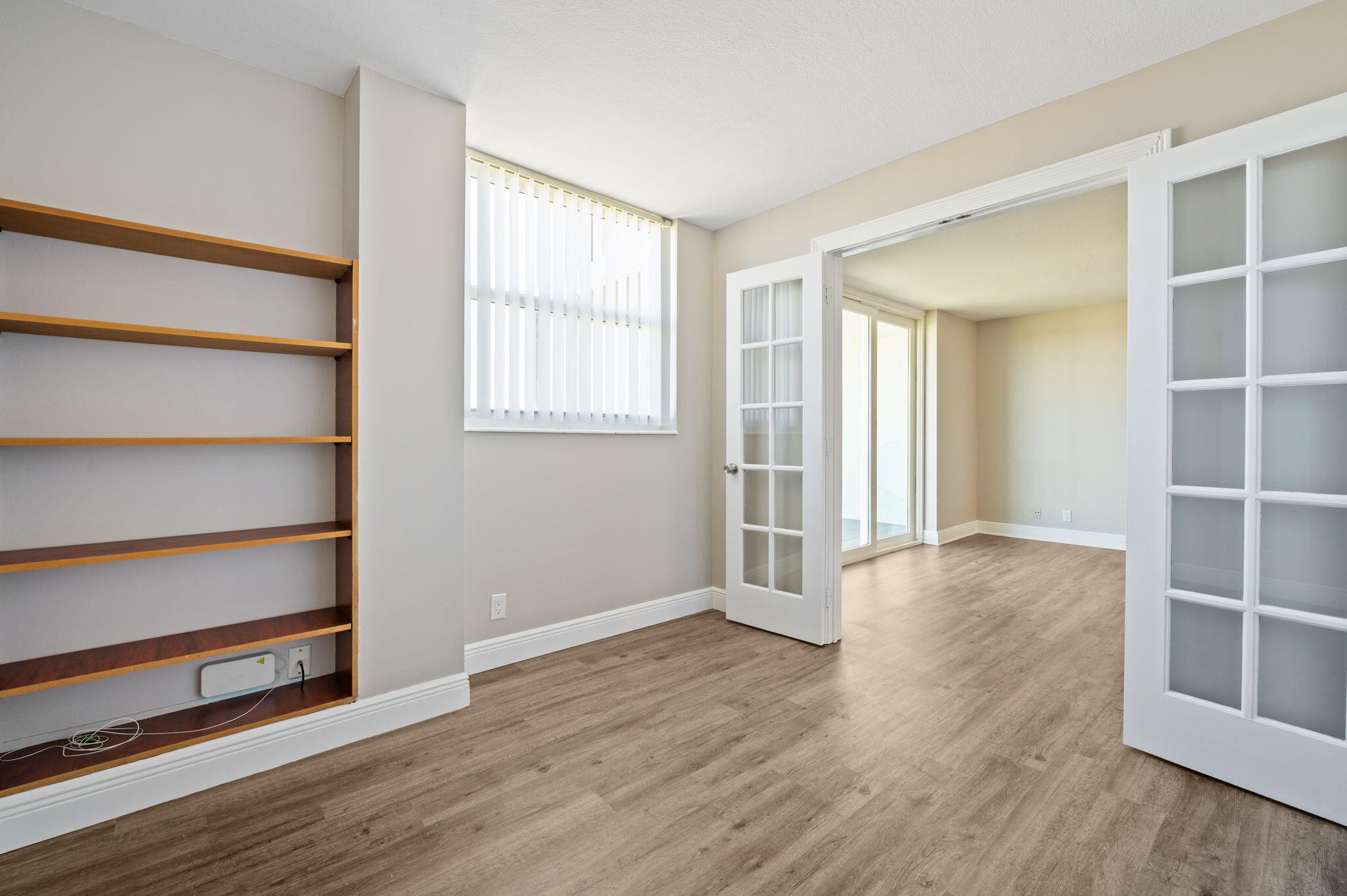 5700 Northwest 2nd Avenue, Unit 410 Boca Raton, FL 33487 - Photo 18 of 34 a view of an empty room with wooden floor and windows