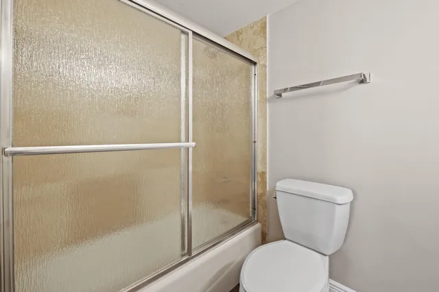 a bathroom with a toilet and a shower