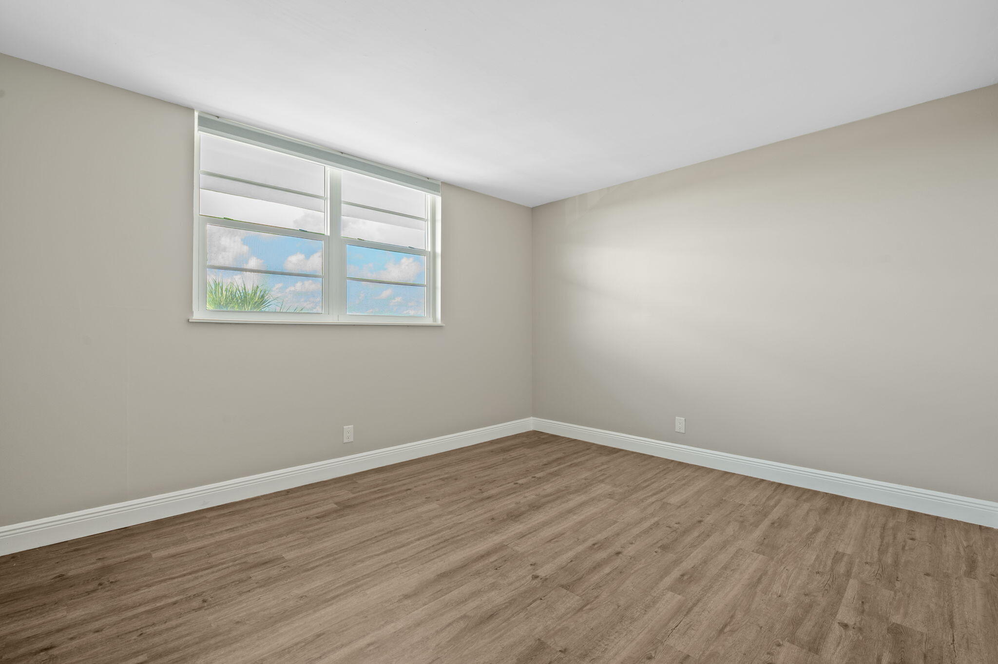 5700 Northwest 2nd Avenue, Unit 410 Boca Raton, FL 33487 - Photo 24 of 34 wooden floor in an empty room with a window