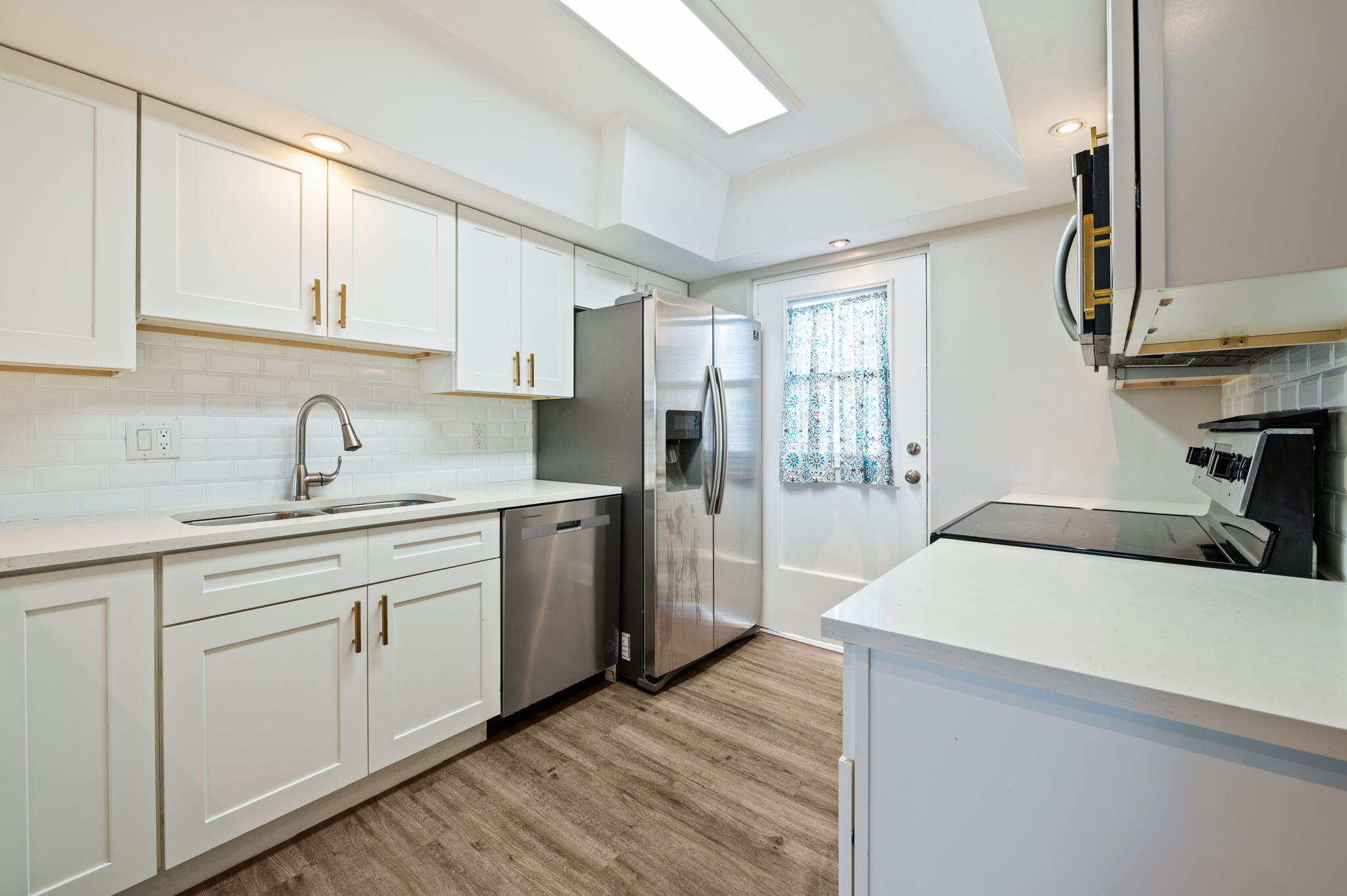 5700 Northwest 2nd Avenue, Unit 410 Boca Raton, FL 33487 - Photo 9 of 34 a kitchen with sink a refrigerator and cabinets