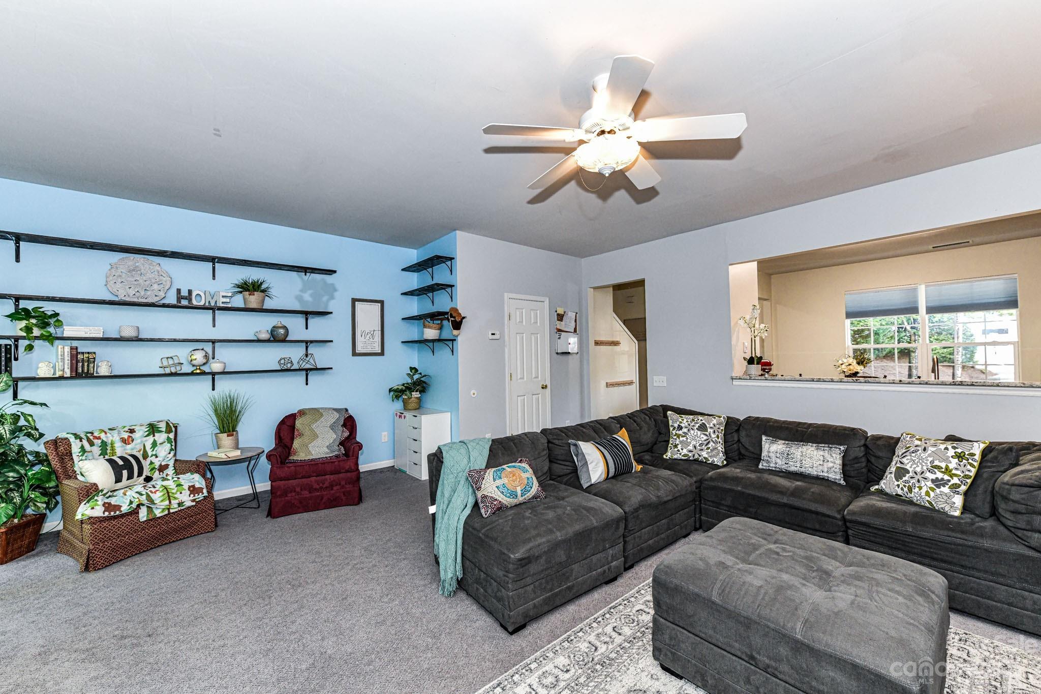 6991 Rothchild Drive Charlotte, NC 28270 - Photo 11 of 37 a living room with furniture and a chandelier