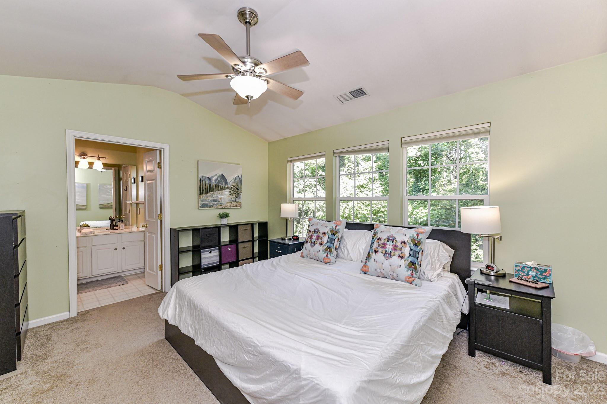 6991 Rothchild Drive Charlotte, NC 28270 - Photo 15 of 37 a bedroom with a large bed and a chandelier