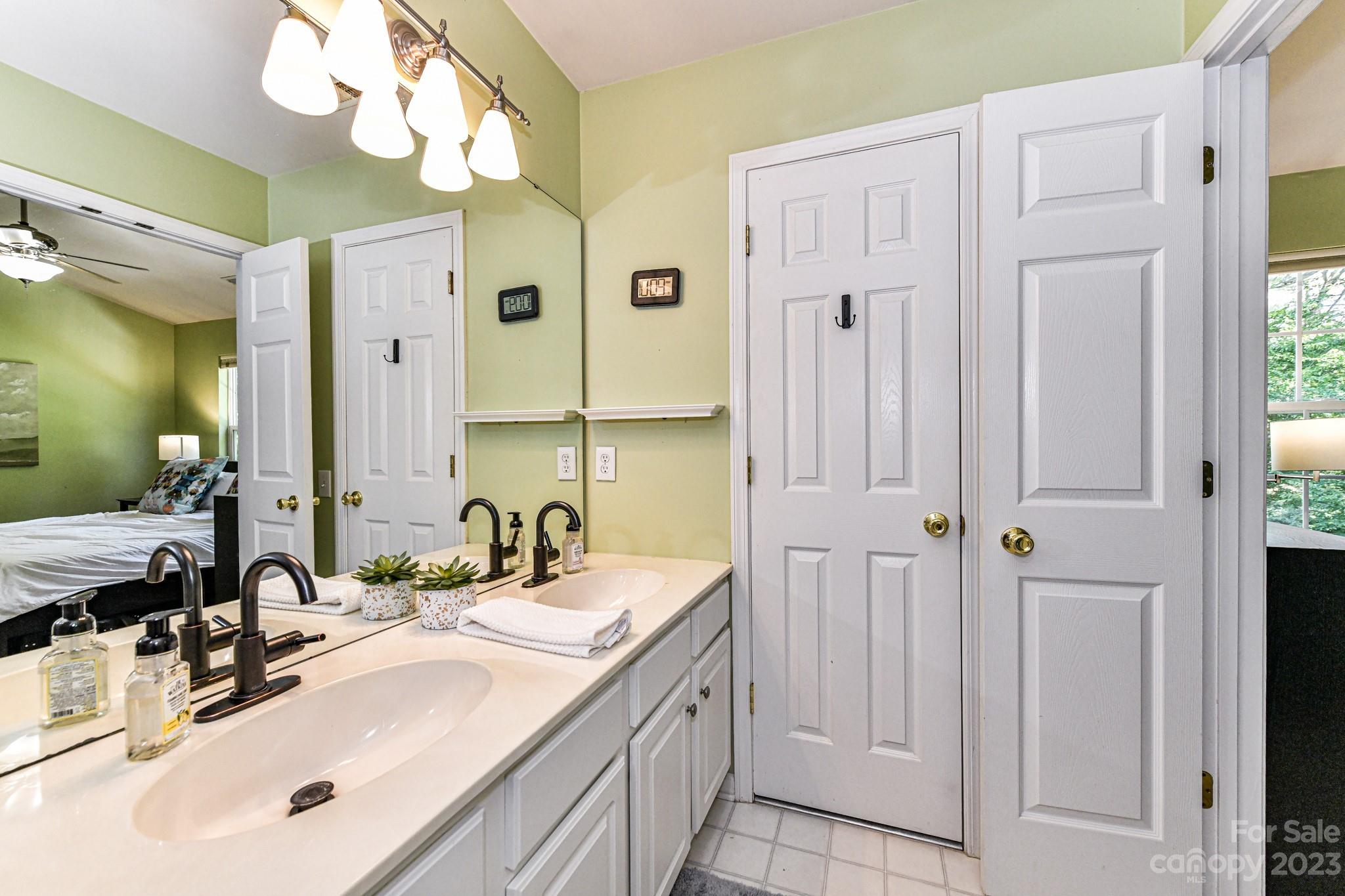 6991 Rothchild Drive Charlotte, NC 28270 - Photo 19 of 37 a bathroom with a double vanity sink and a mirror