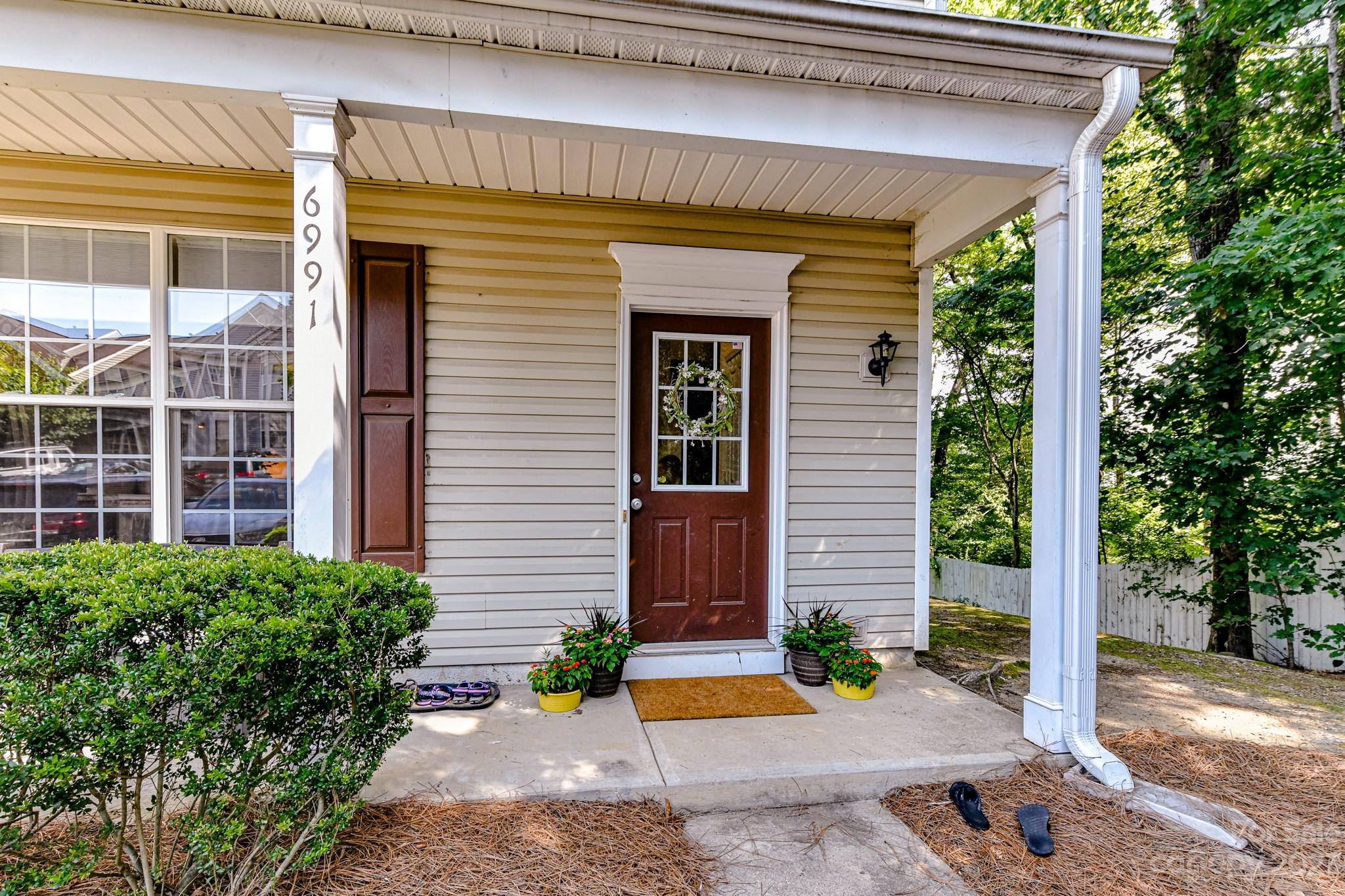6991 Rothchild Drive Charlotte, NC 28270 - Photo 2 of 37 a view of a house with potted plants