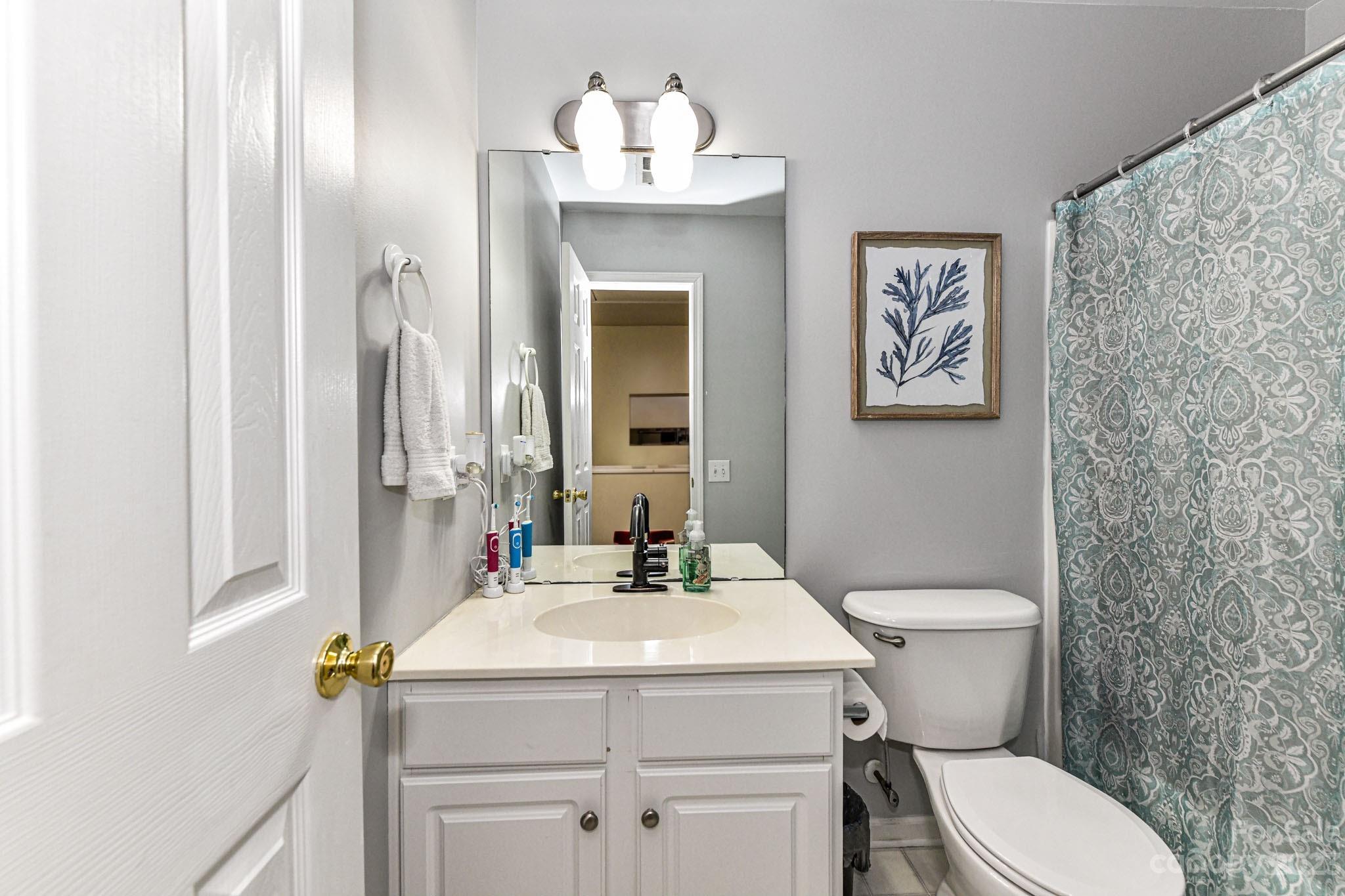 6991 Rothchild Drive Charlotte, NC 28270 - Photo 24 of 37 a bathroom with a toilet sink and mirror
