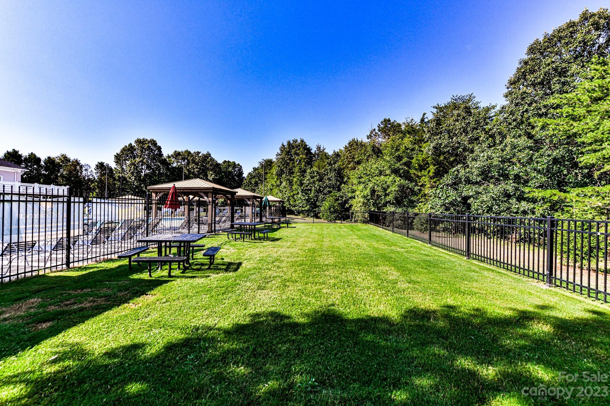 6991 Rothchild Drive Charlotte, NC 28270 - Photo 33 of 37 a view of a swimming pool with a garden