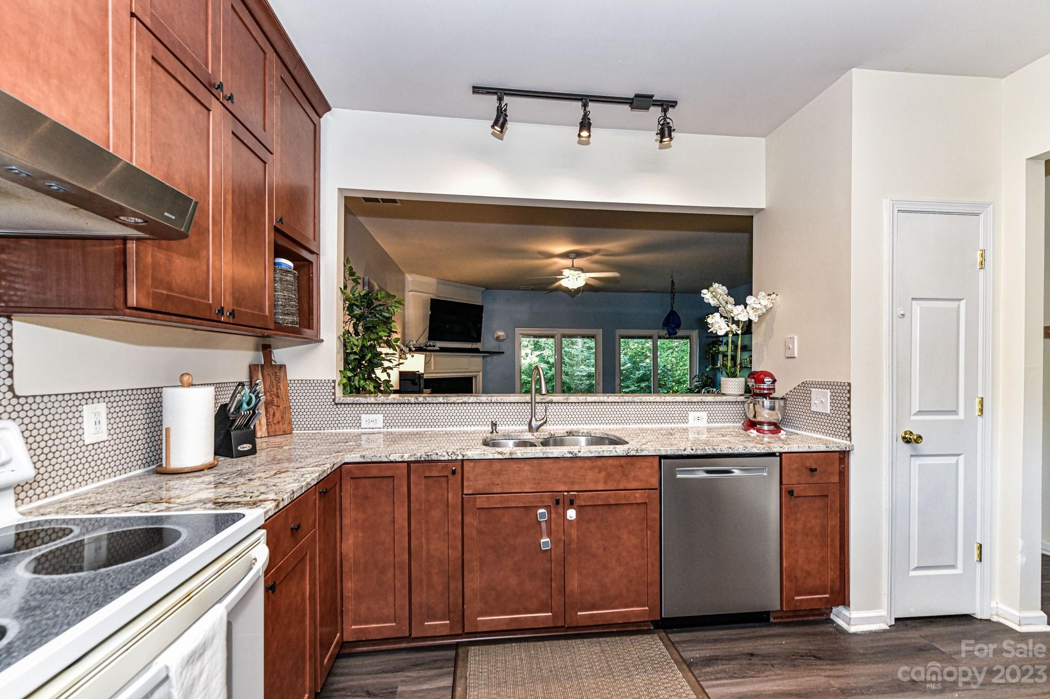 6991 Rothchild Drive Charlotte, NC 28270 - Photo 7 of 37 a kitchen with stainless steel appliances granite countertop a sink and cabinets