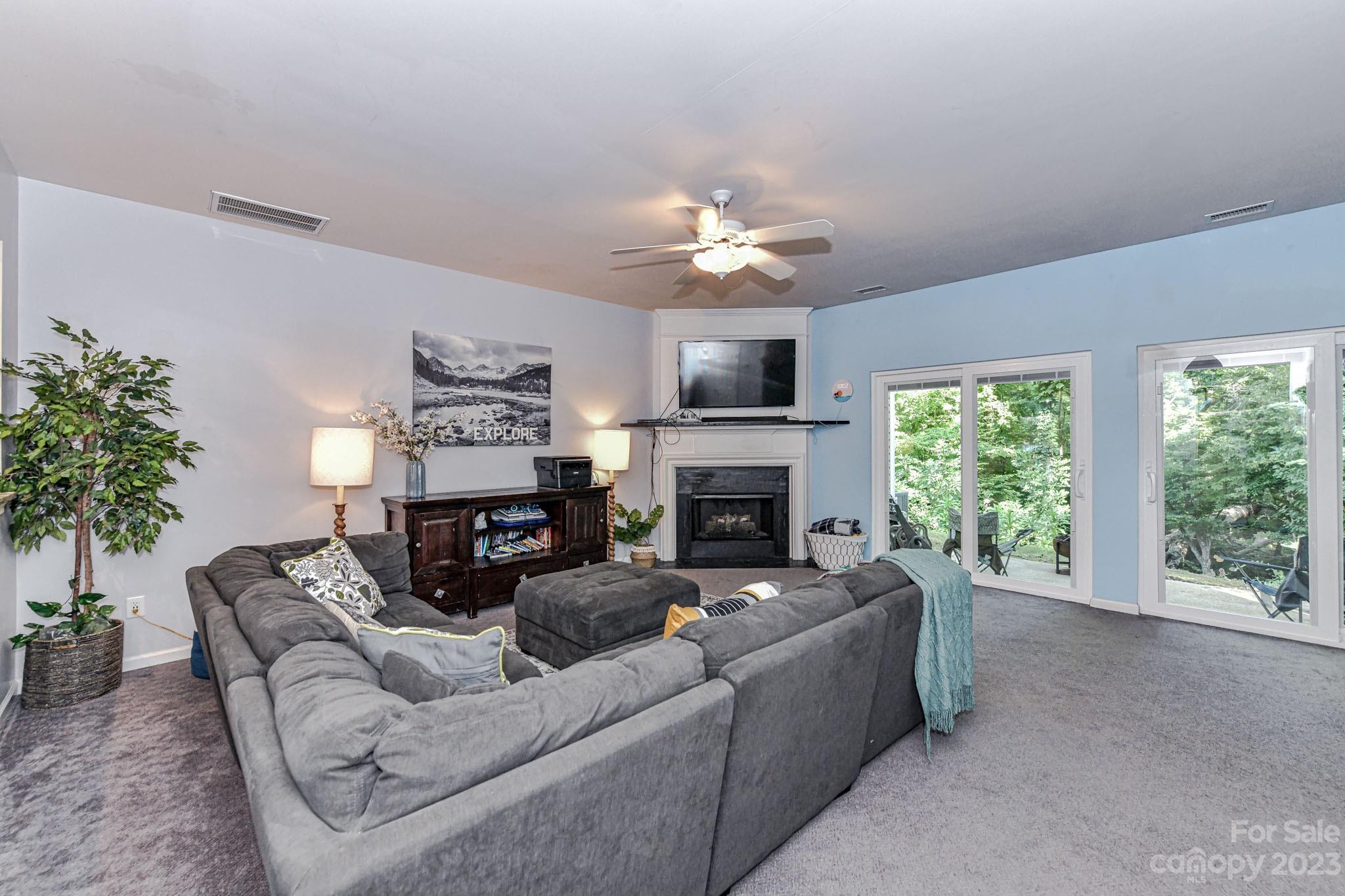 6991 Rothchild Drive Charlotte, NC 28270 - Photo 8 of 37 a living room with furniture a large window and a fireplace