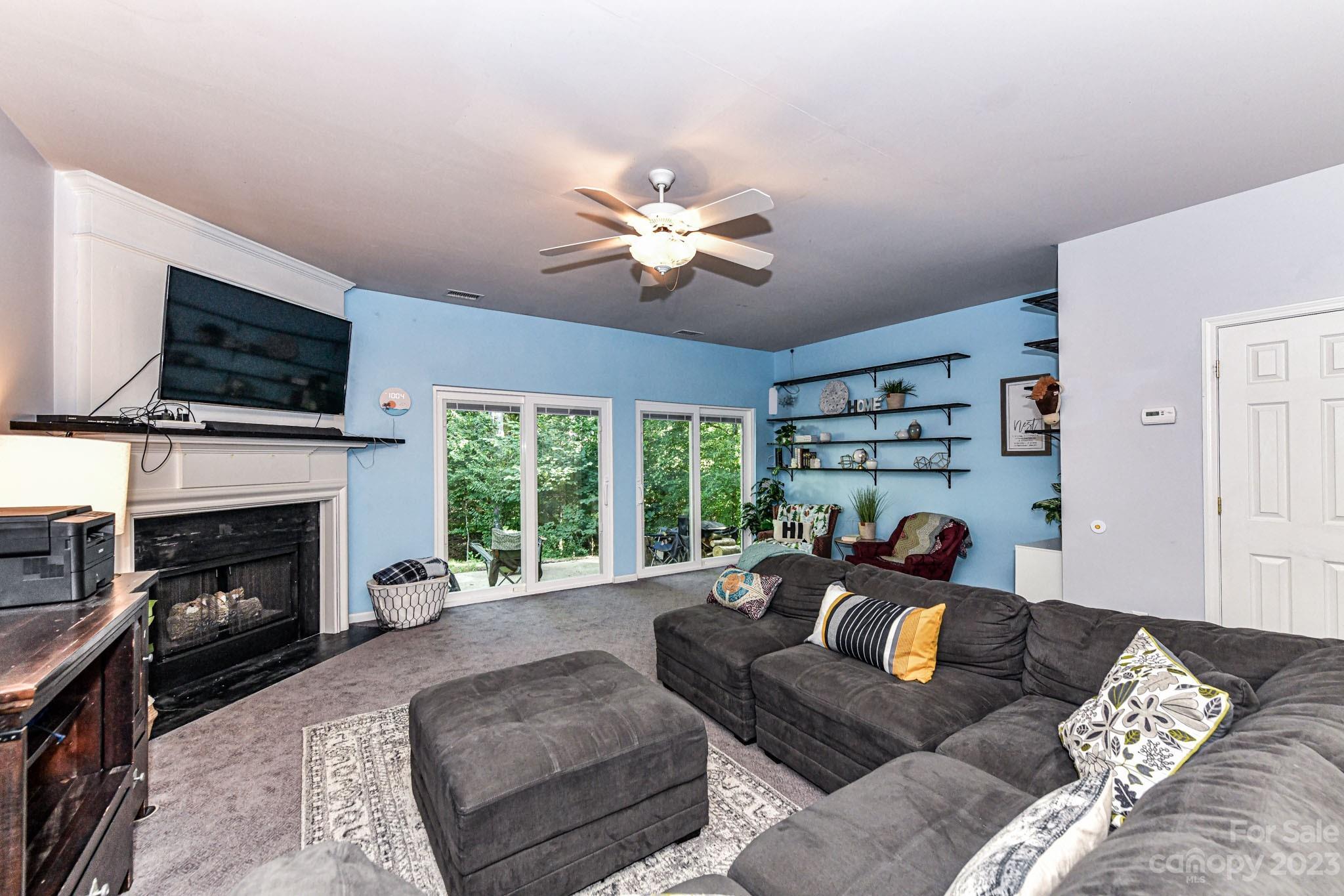 6991 Rothchild Drive Charlotte, NC 28270 - Photo 10 of 37 a living room with furniture fireplace and a flat screen tv