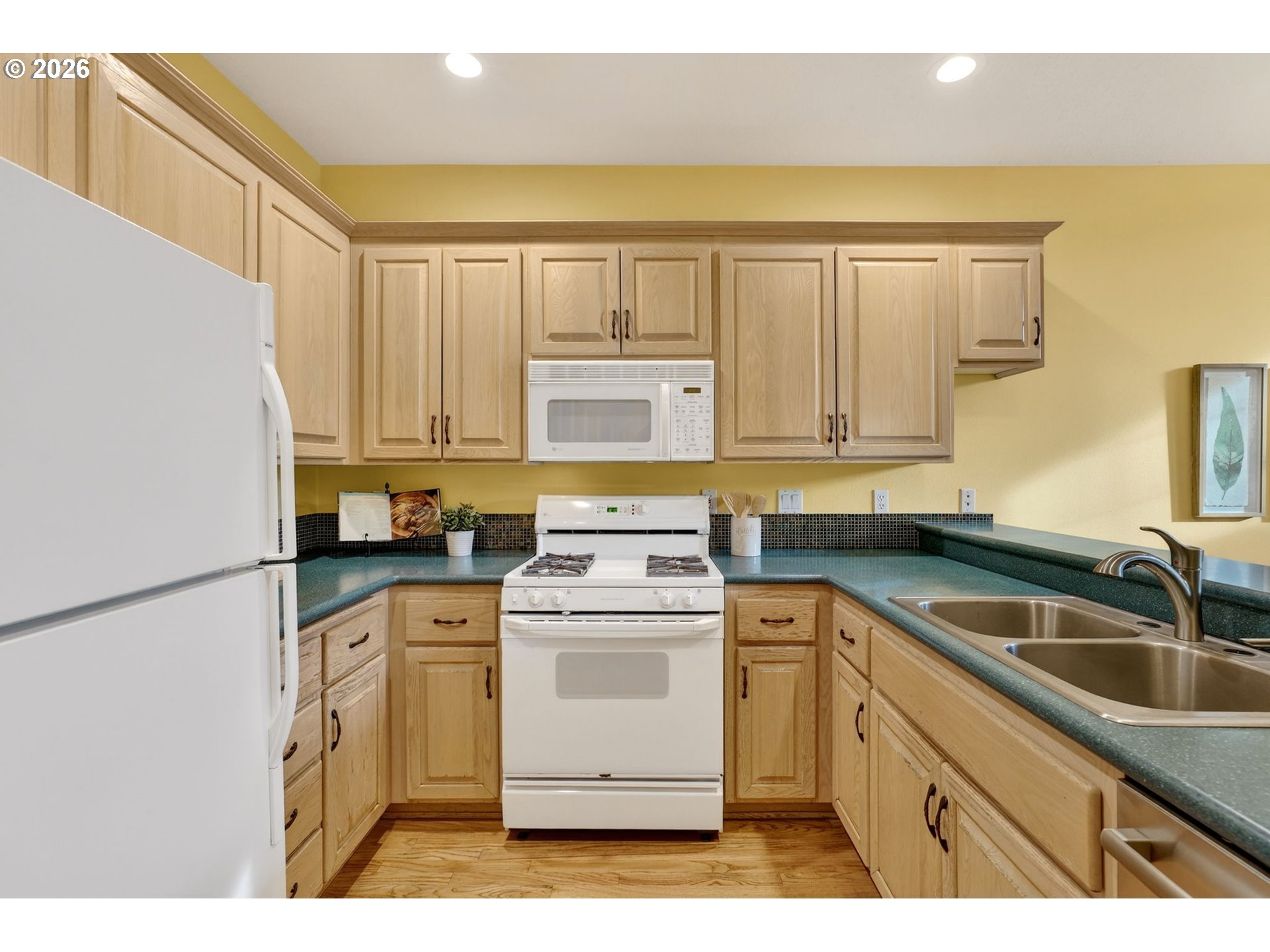 4714 Southwest 2nd Court Portland, OR 97239 - Photo 6 of 44 a kitchen with a sink stove and refrigerator