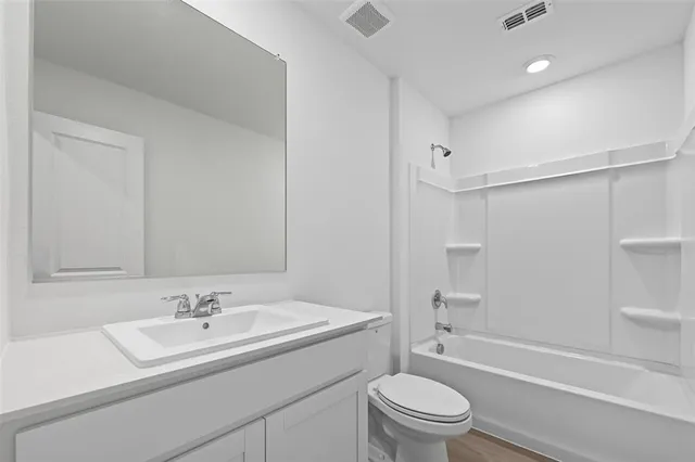 a bathroom with a sink toilet tub and shower