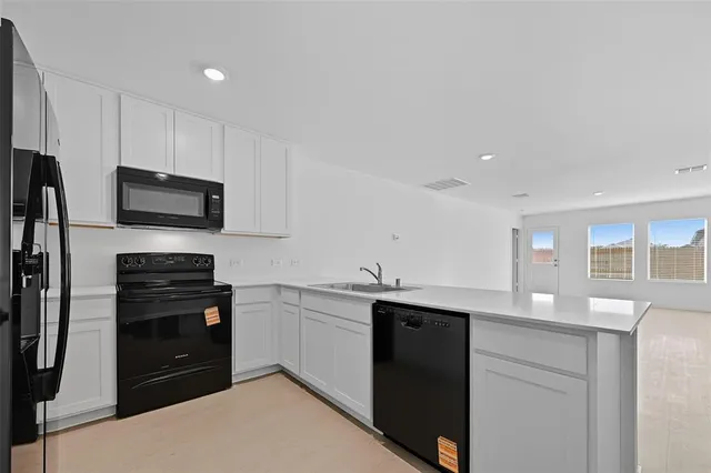 a kitchen with a sink stainless steel appliances and cabinets
