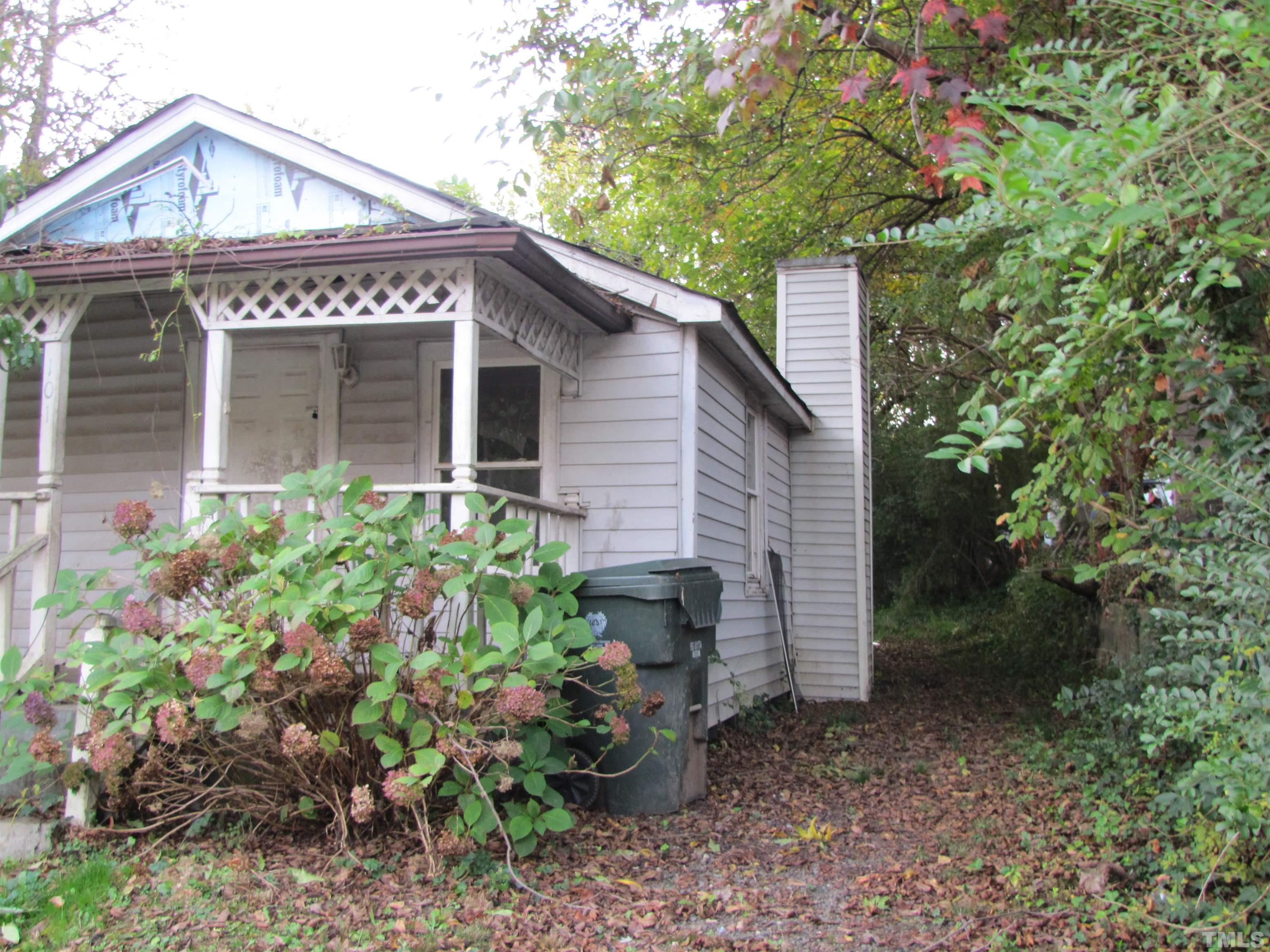 101 Prospect Avenue Raleigh, NC 27603 - Photo 2 of 4 a view of a house with potted plants and large trees