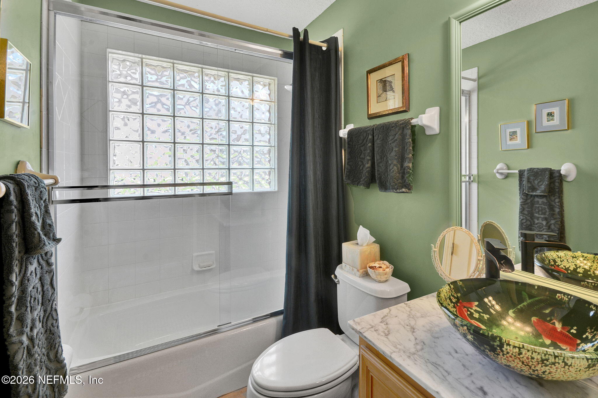 5950 West Shores Road Orange Park, FL 32003 - Photo 30 of 42 a bathroom with a sink toilet and shower