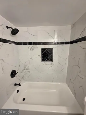 a bathroom with a bathtub and shower