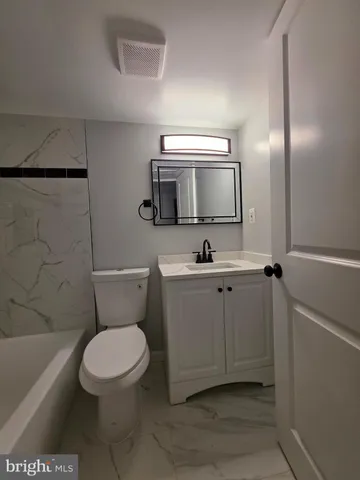 a bathroom with a toilet a sink and bathtub