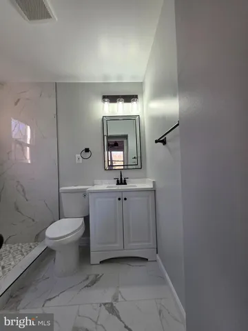 a bathroom with a toilet sink and shower