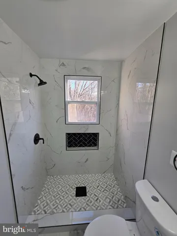 a kitchen with a sink a refrigerator a window and cabinets