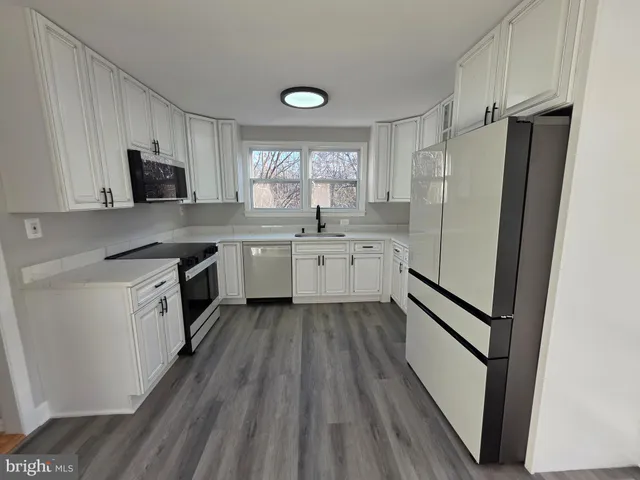 a bathroom with a toilet a sink and a window