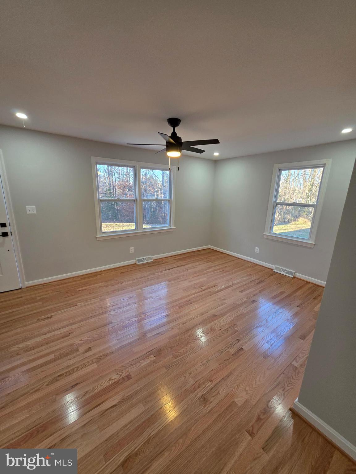 25294 Vista Road Hollywood, MD 20636 - Photo 26 of 53 an empty room with wooden floor and windows