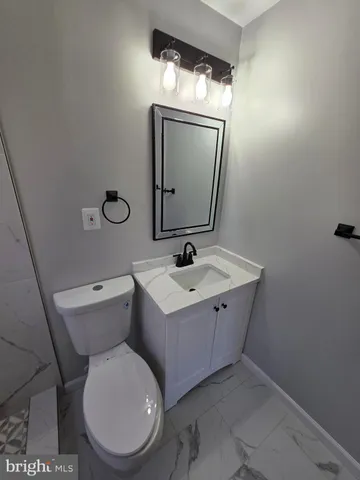 a bathroom with a toilet sink and shower