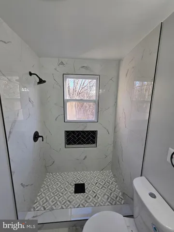 a kitchen with a sink a refrigerator a window and cabinets