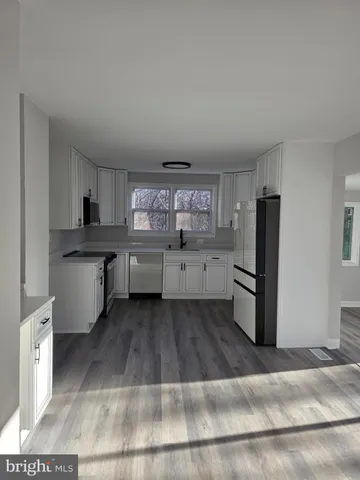 a kitchen with stainless steel appliances granite countertop a refrigerator and stove