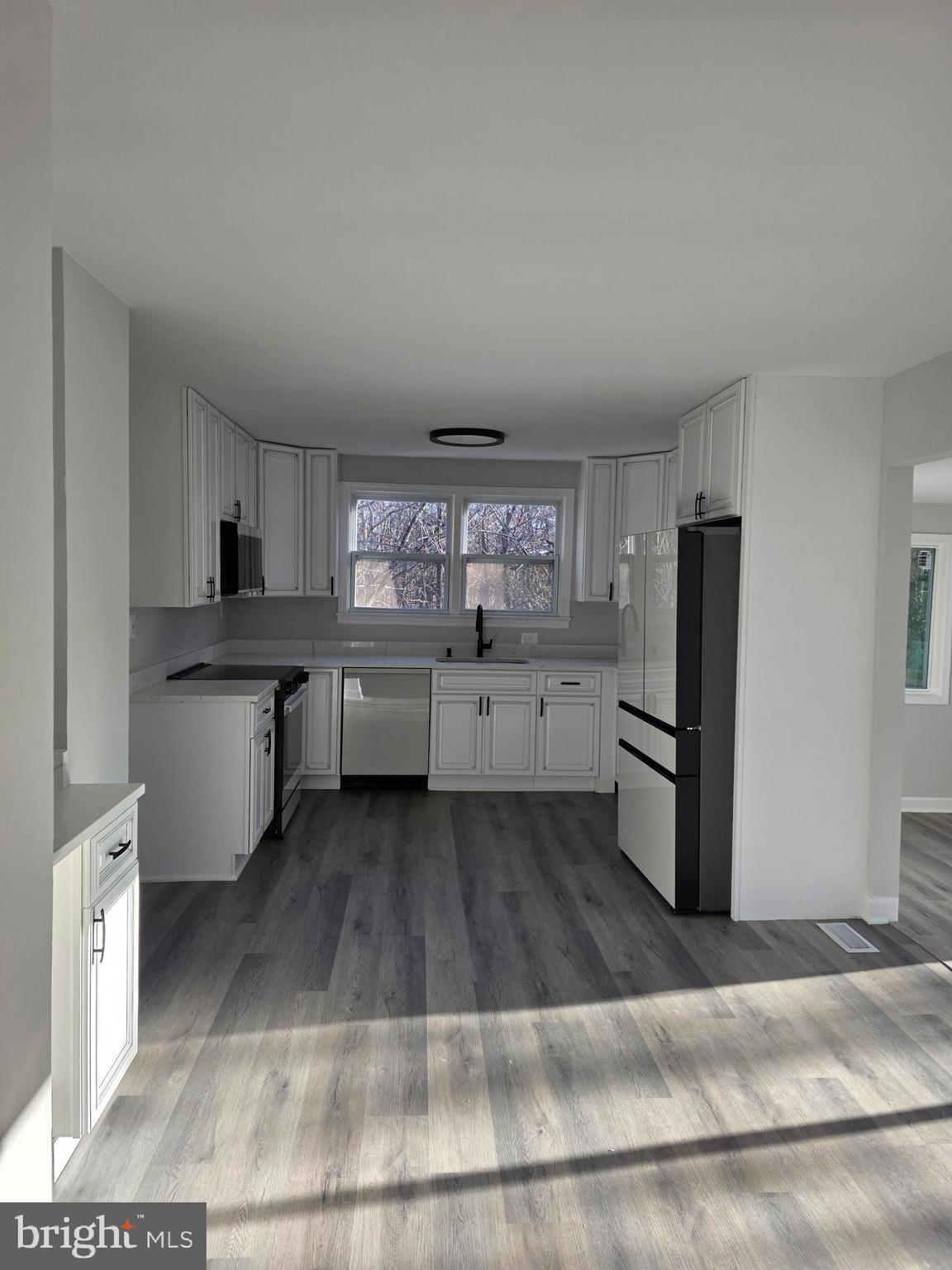 25294 Vista Road Hollywood, MD 20636 - Photo 36 of 53 a kitchen with granite countertop a refrigerator and a stove
