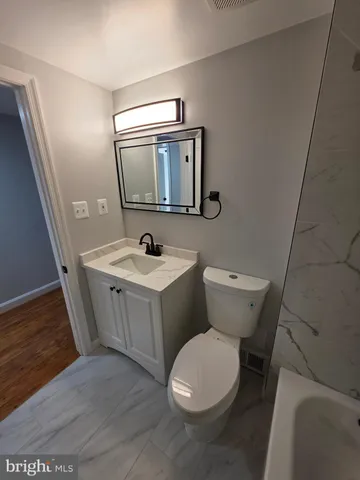 a bathroom with a toilet a sink and bathtub