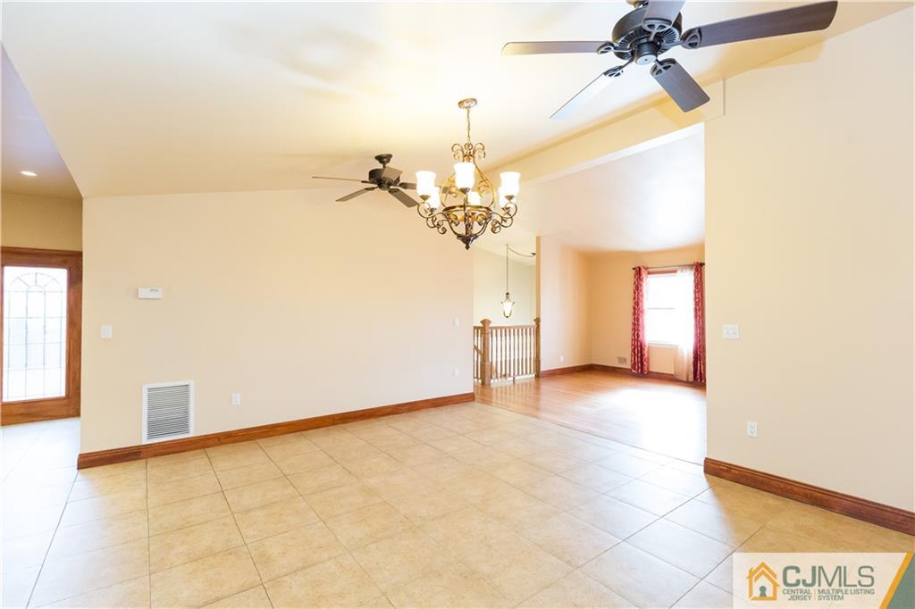 19 Bodnarik Road Edison, NJ 08837 - Photo 8 of 50 a view of a livingroom with a chandelier fan and a window