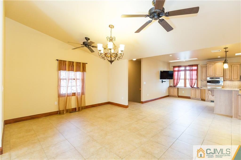 19 Bodnarik Road Edison, NJ 08837 - Photo 10 of 50 a view of a kitchen with furniture and a ceiling fan
