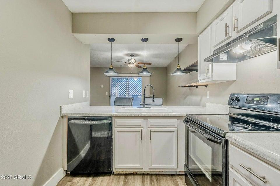 1826 N Spring, Unit 201 Mesa, AZ 85203 - Photo 5 of 17 a kitchen with a stove cabinets and wooden floor