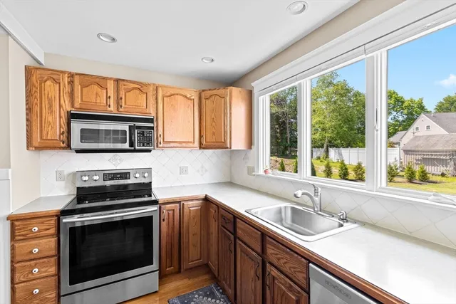 a kitchen with a sink stove and microwave