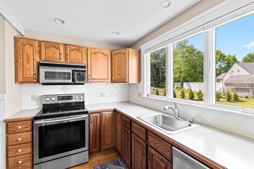 157 Branch Street Scituate, MA 02066 - Photo 13 of 41 a kitchen with a sink stove and microwave
