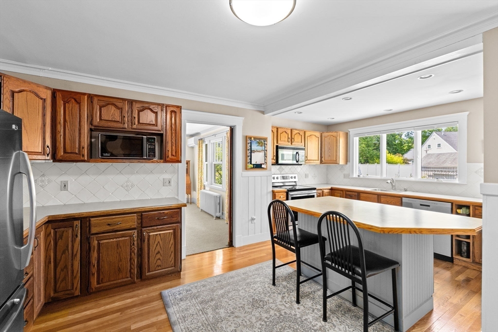 157 Branch Street Scituate, MA 02066 - Photo 15 of 41 a kitchen with a table chairs sink and cabinets