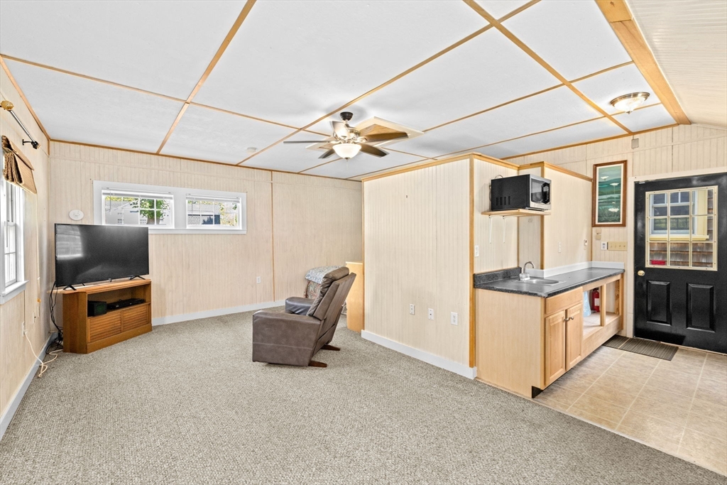 157 Branch Street Scituate, MA 02066 - Photo 31 of 41 a kitchen with stainless steel appliances kitchen island granite countertop a stove and a sink