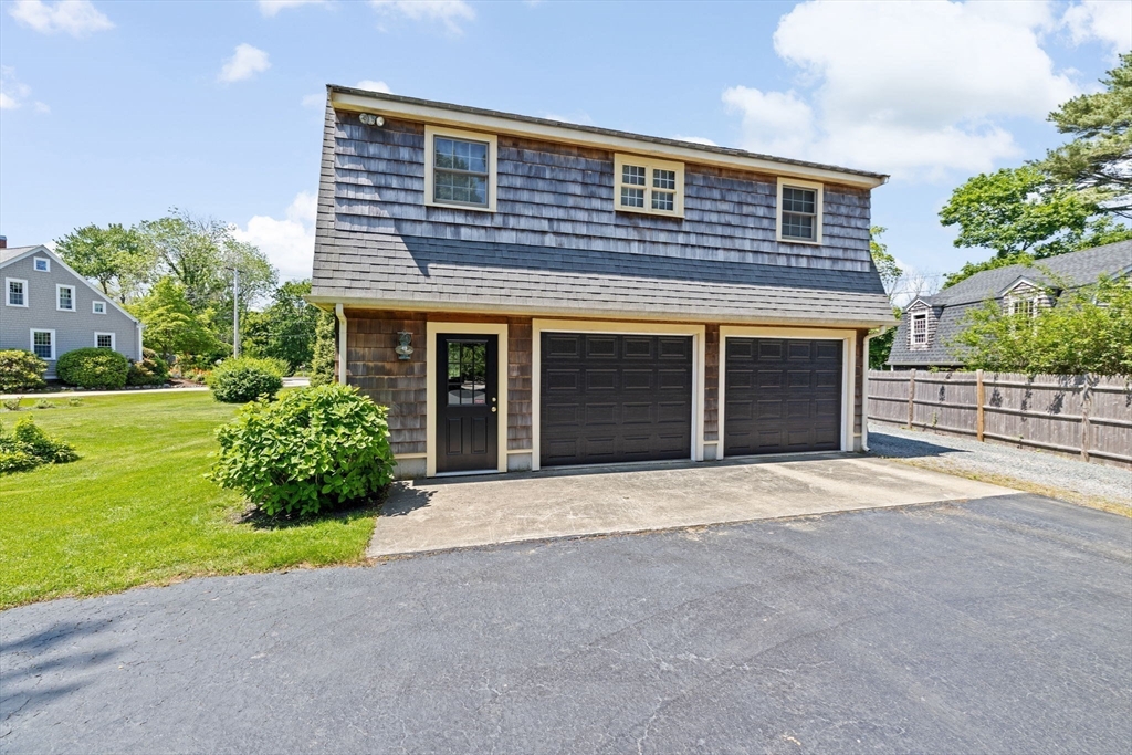 157 Branch Street Scituate, MA 02066 - Photo 33 of 41 a front view of a house with a yard and garage