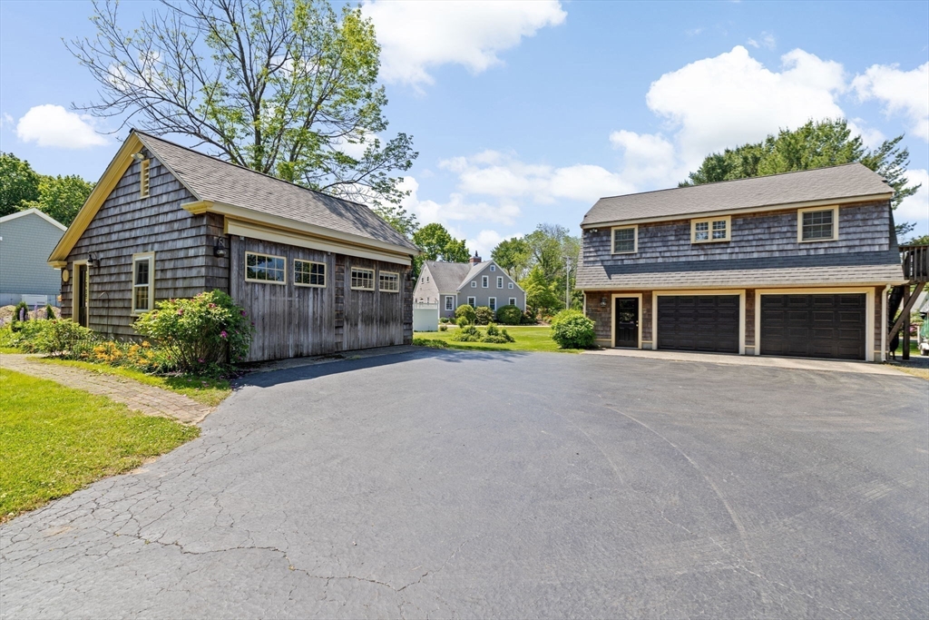 157 Branch Street Scituate, MA 02066 - Photo 4 of 41 a front view of a house with a yard and garage