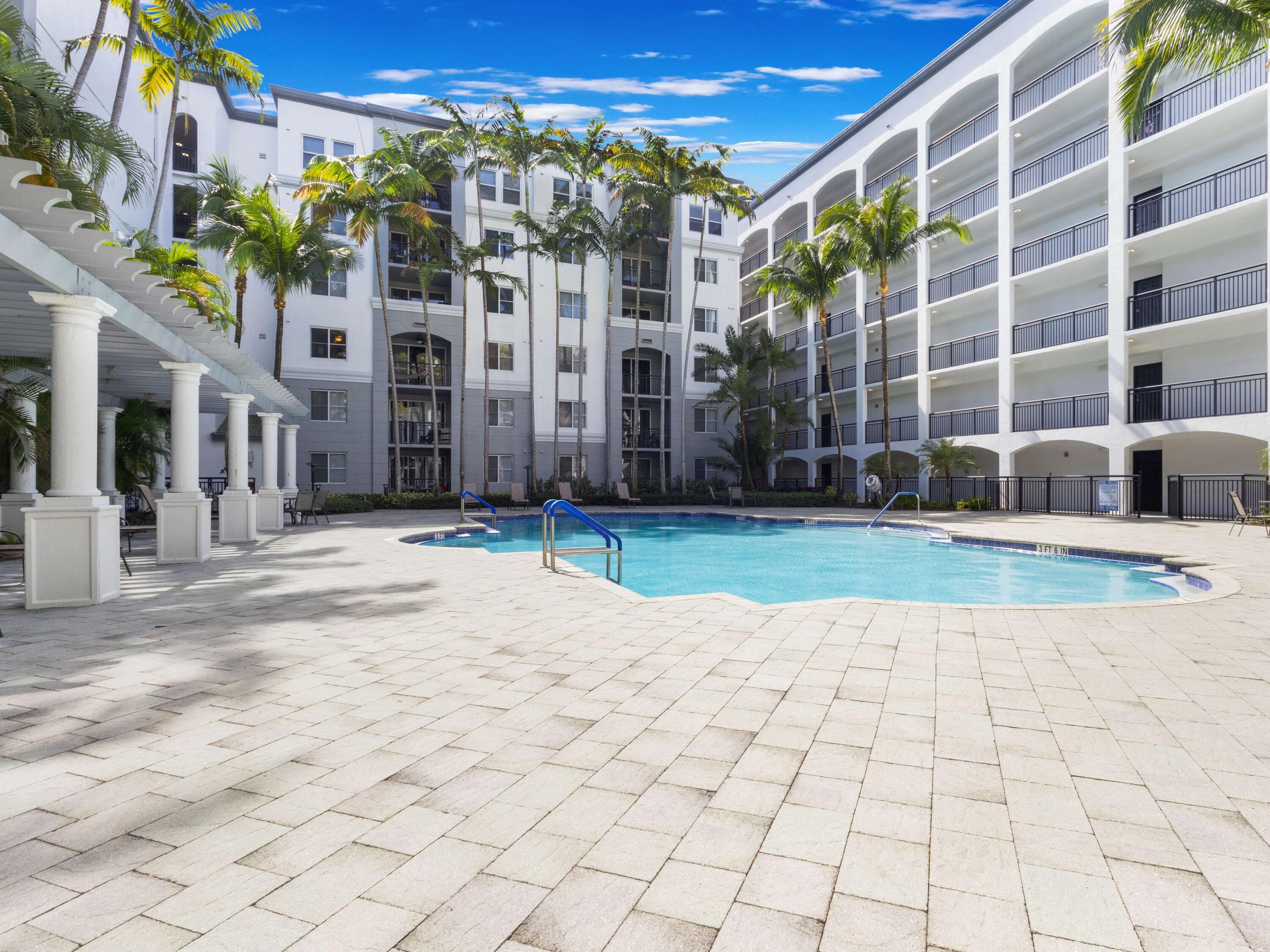 1690 Renaissance Commons Boulevard, Unit 1412 Boynton Beach, FL 33426 - Photo 30 of 49 a view of a building with a yard