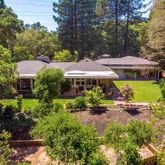a view of a house with a yard and sitting area