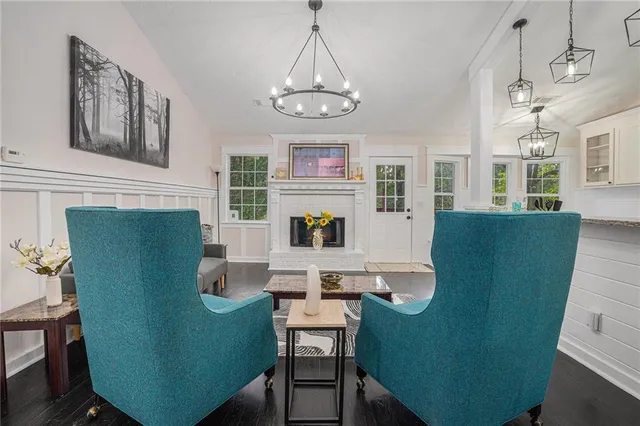 a living room with furniture and a chandelier