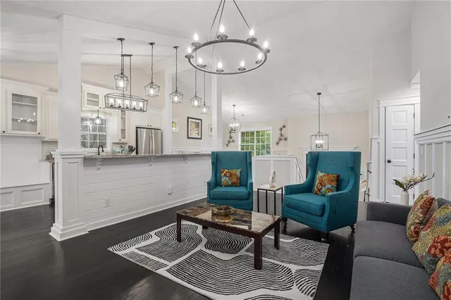 a living room with furniture and a chandelier