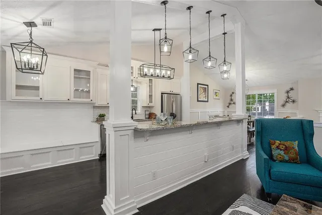a view of a kitchen with a sink stainless steel appliances and cabinets