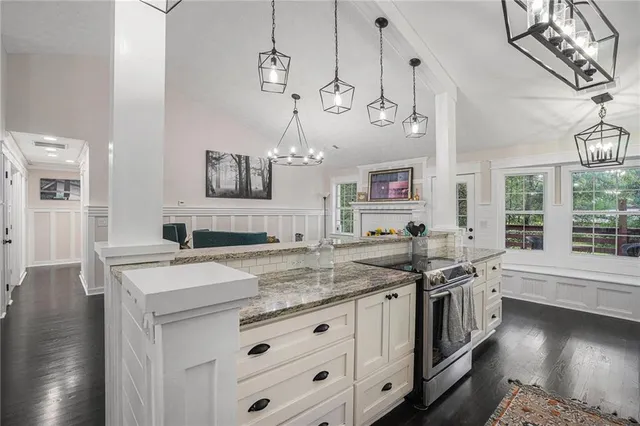 a kitchen with a stove and a chandelier